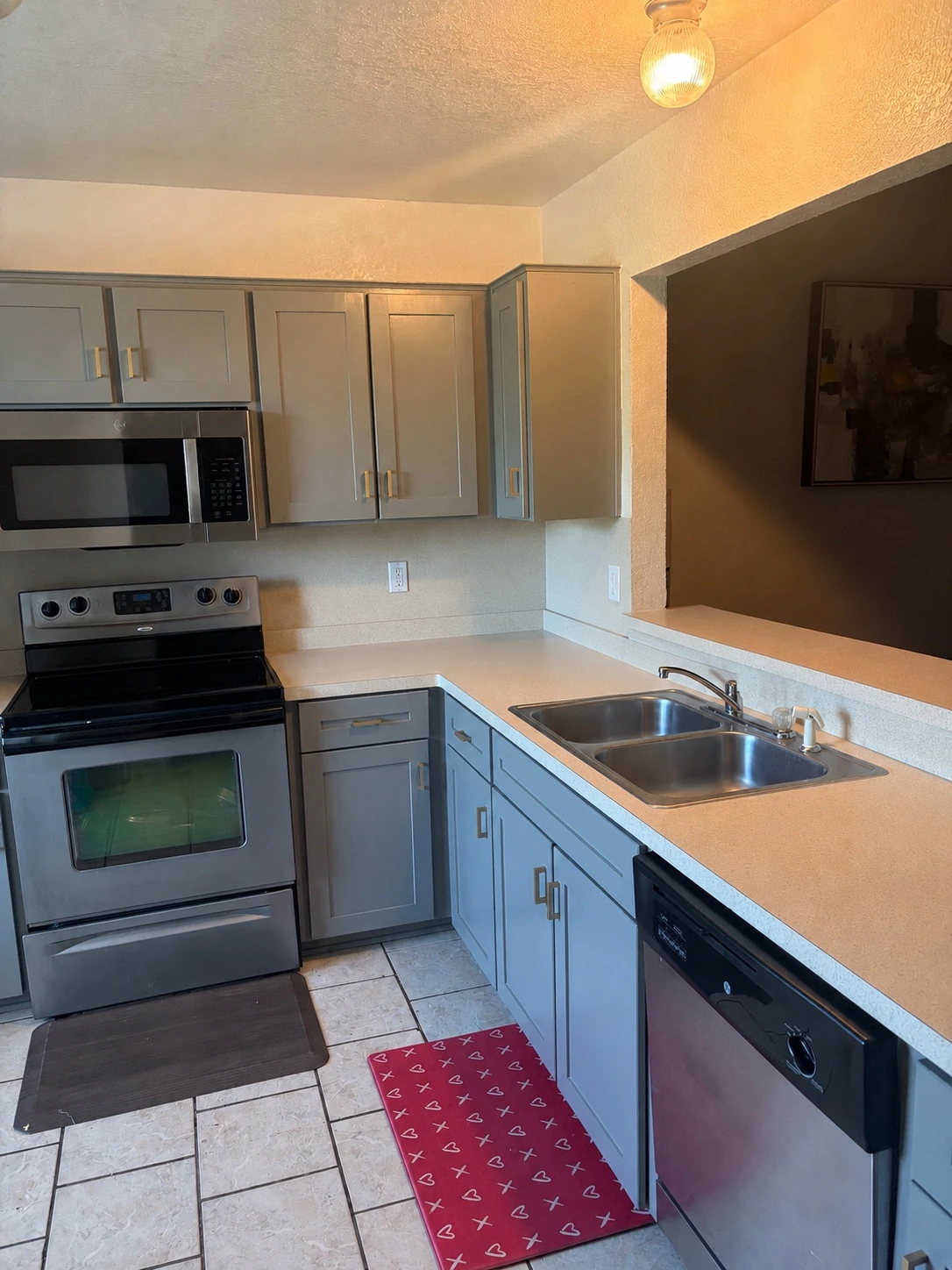 Completed updated kitchen with gray cabinets and new detailing